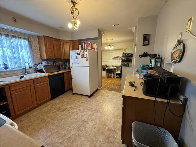a kitchen with refrigerator and window
