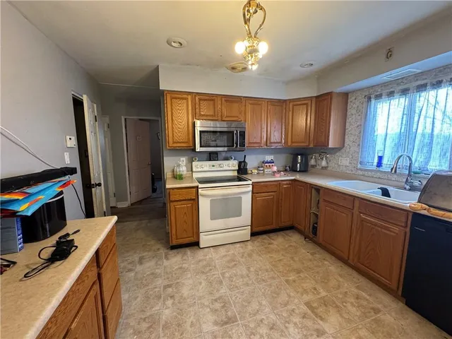a kitchen with a sink cabinets and window