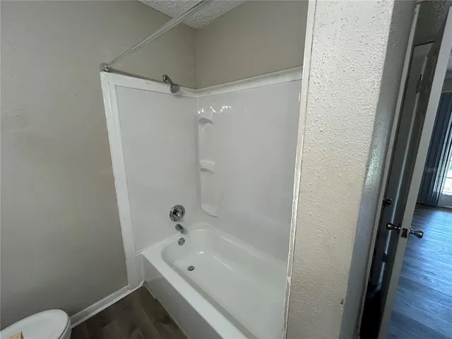a bathroom with a tub a sink and a toilet