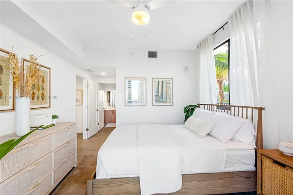a spacious bedroom with a large bed and a window
