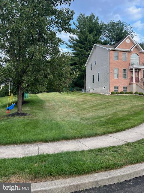 Charming home with lush green lawn.