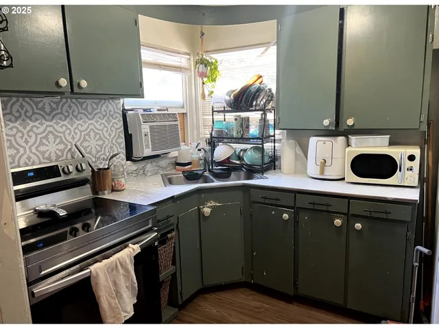a kitchen with a sink stove and cabinets