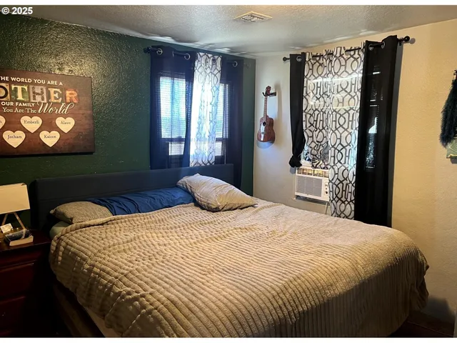 a bedroom with a bed and a window