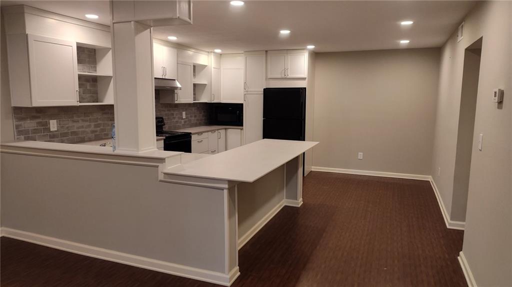 a kitchen with a refrigerator and a sink