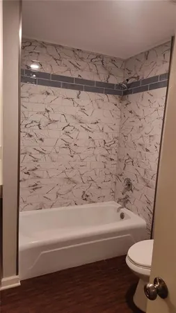 a bathroom with a toilet and a shower