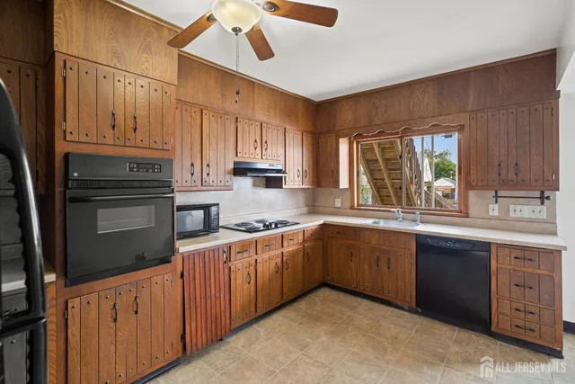 a kitchen with granite countertop cabinets stainless steel appliances a sink and a window