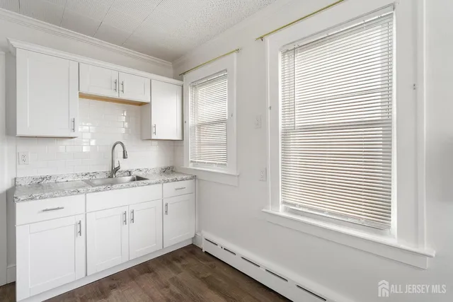 a kitchen with a sink cabinets and window