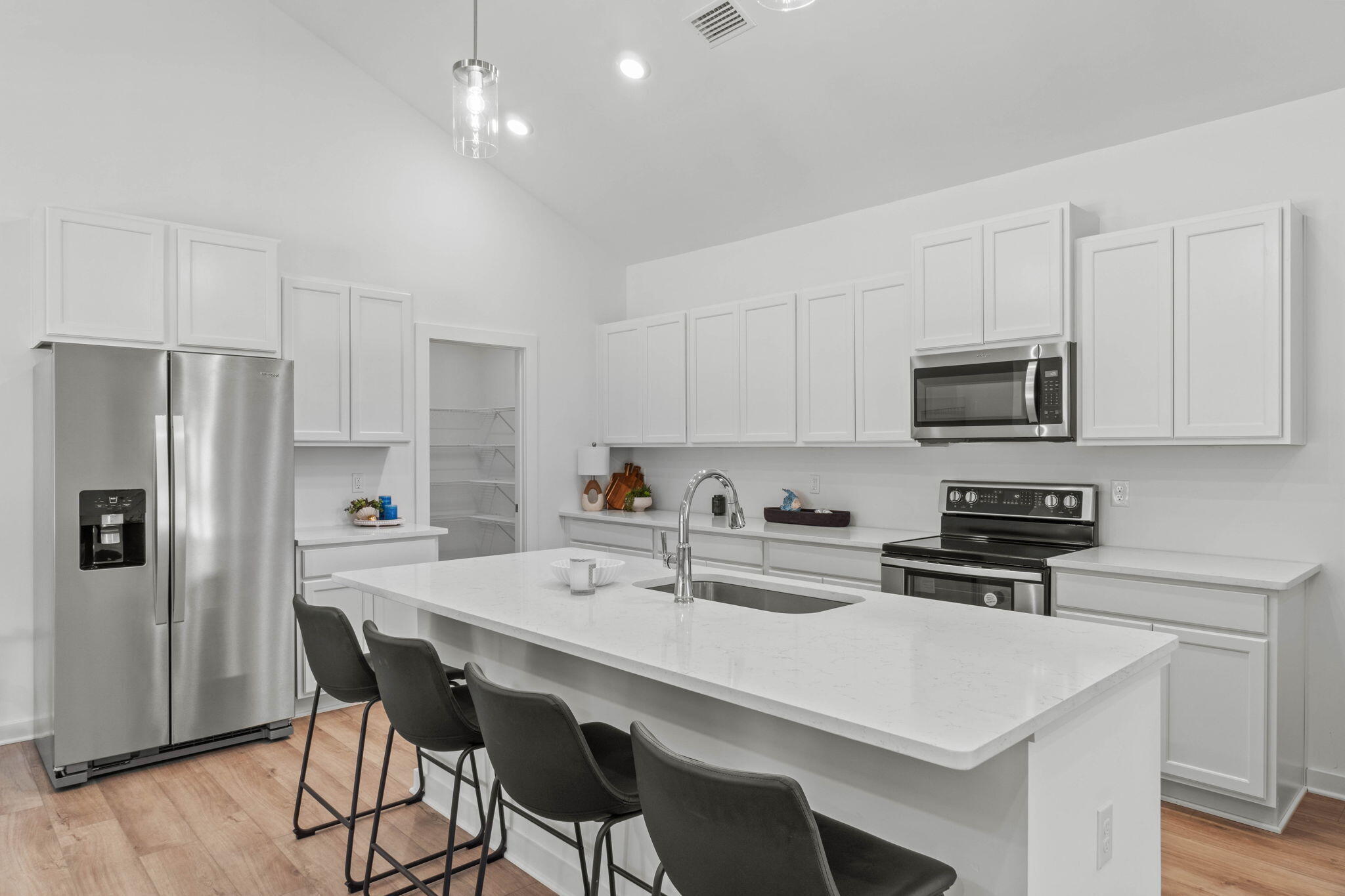70 Parkside Street Freeport, FL 32439 - Photo 8 of 40 a kitchen with stainless steel appliances a stove a sink a microwave a refrigerator and white cabinets