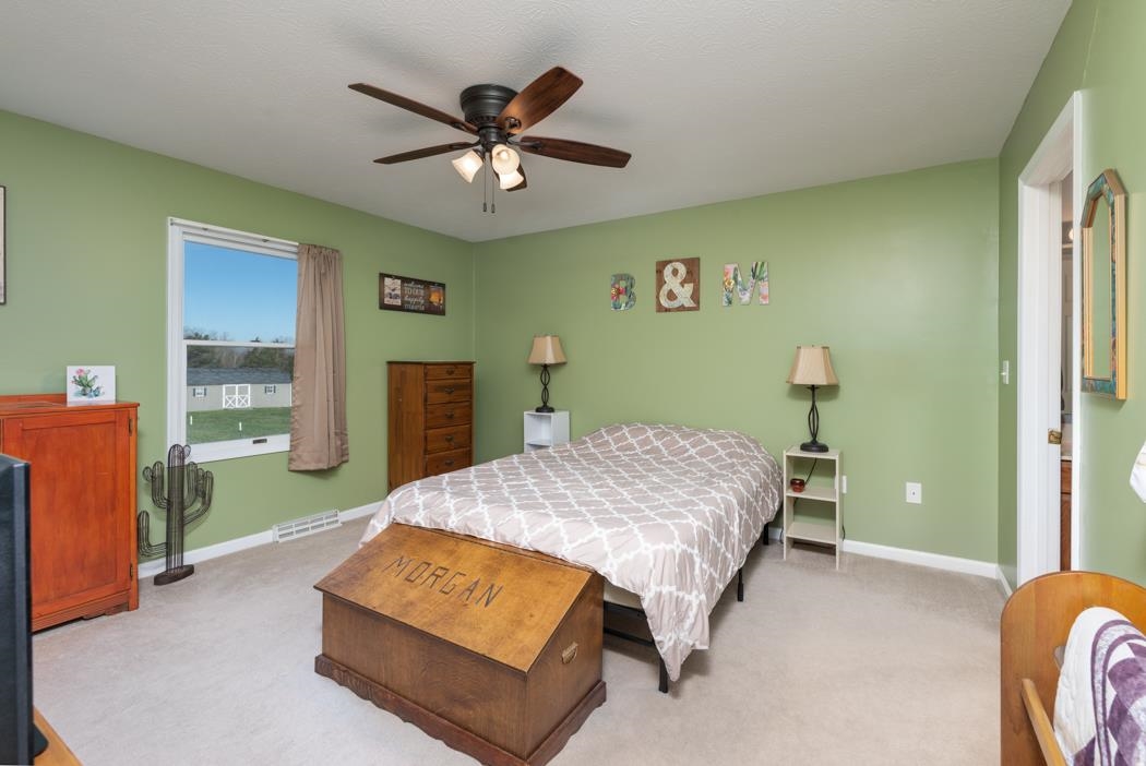 816 Battlefield Road Fort Defiance, VA 24437 - Photo 32 of 49 a bedroom with a bed and a chandelier