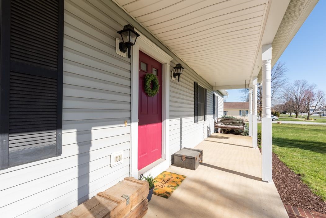 816 Battlefield Road Fort Defiance, VA 24437 - Photo 5 of 49 a view of a porch with couches chairs potted plants and floor to ceiling window