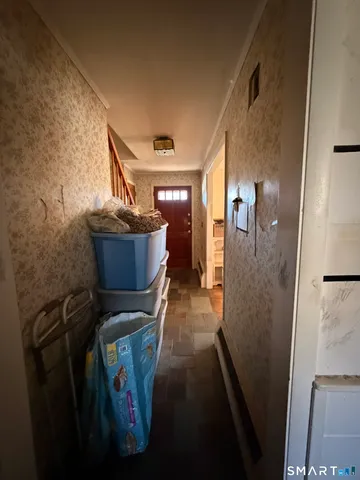 a view of entryway and hall with wooden floor