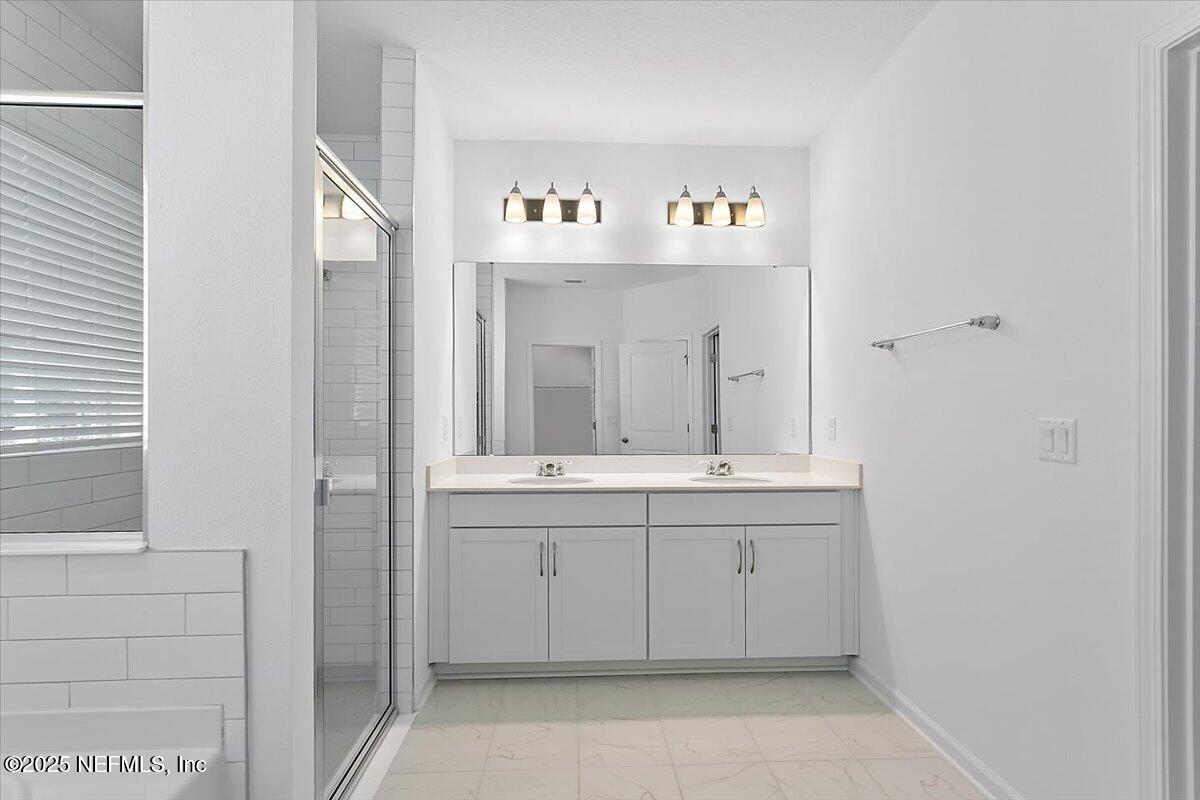 107 Crew Ct Street St. Augustine, FL 32092 - Photo 12 of 31 a bathroom with a sink and a mirror