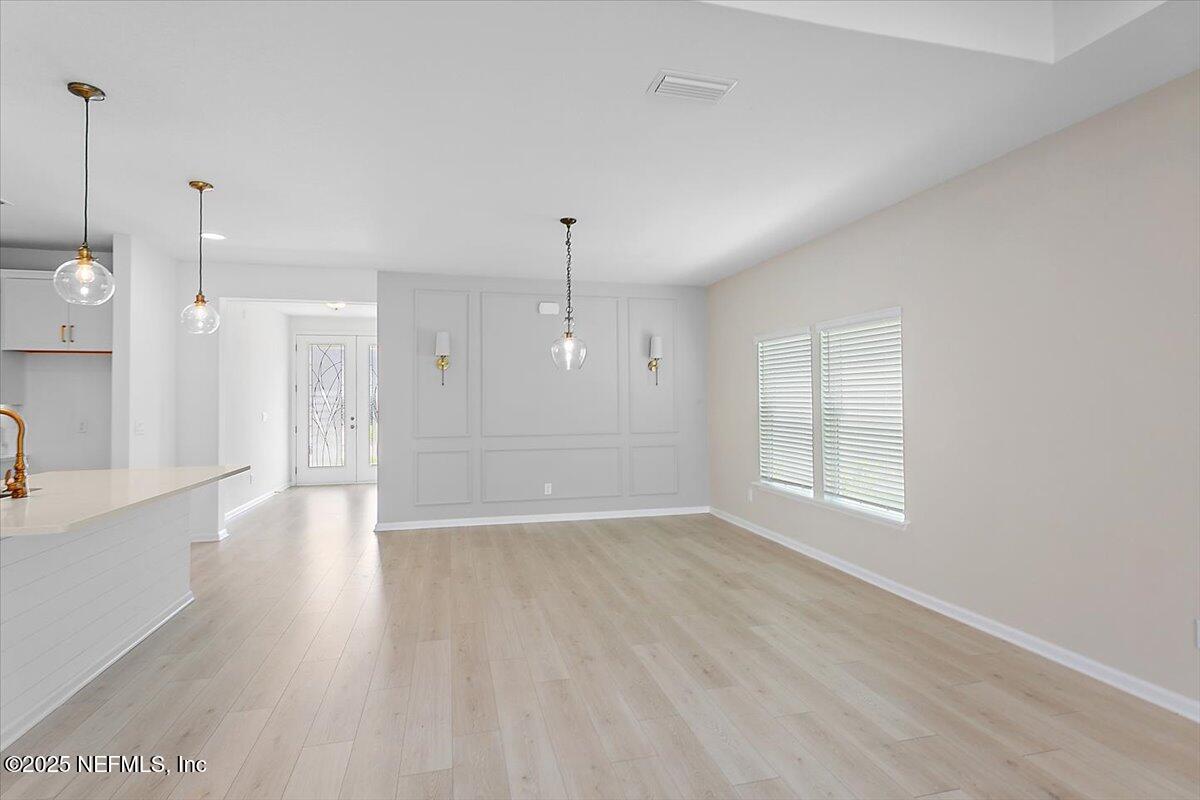 107 Crew Ct Street St. Augustine, FL 32092 - Photo 6 of 31 a view of an empty room with wooden floor and a window