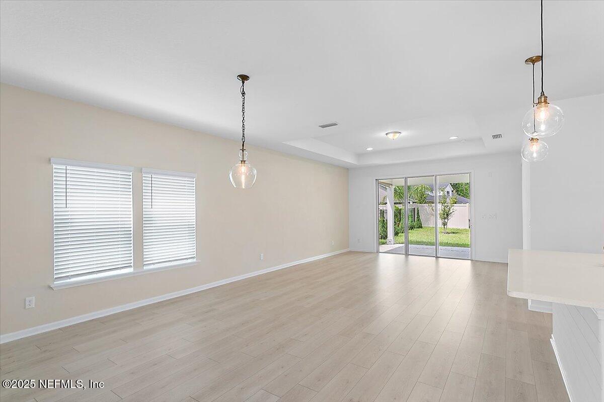 107 Crew Ct Street St. Augustine, FL 32092 - Photo 7 of 31 a view of an empty room with wooden floor and a window