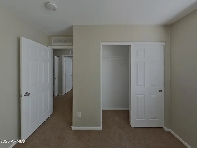 a view of a room with wooden floor and a window
