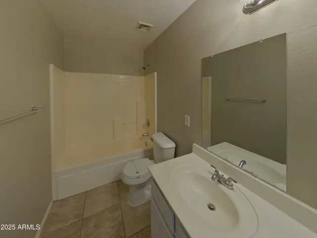 a spacious bathroom with a shower sink and mirror