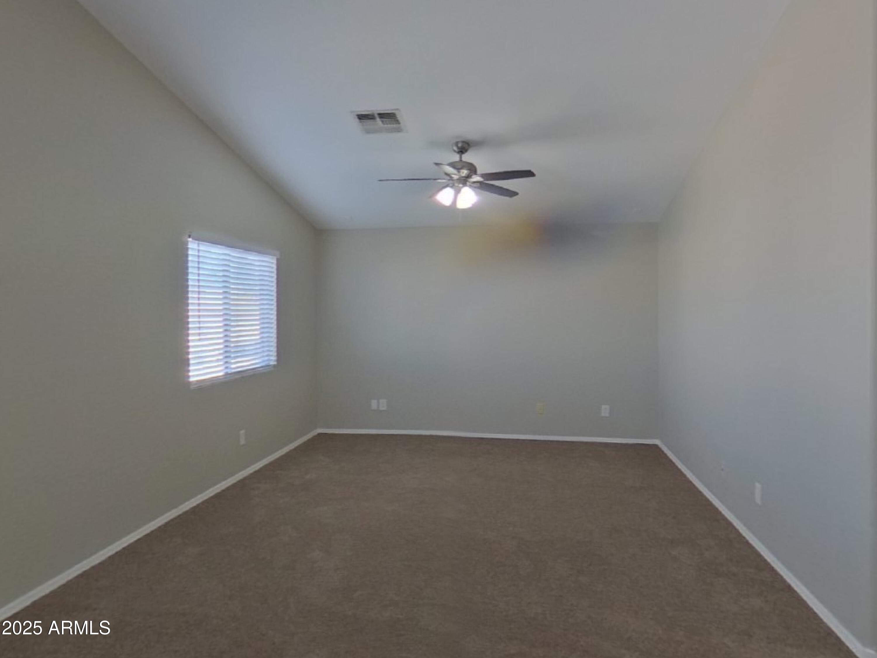 43846 West Magnolia Road Maricopa, AZ 85138 - Photo 16 of 18 an empty room with a window and a ceiling fan
