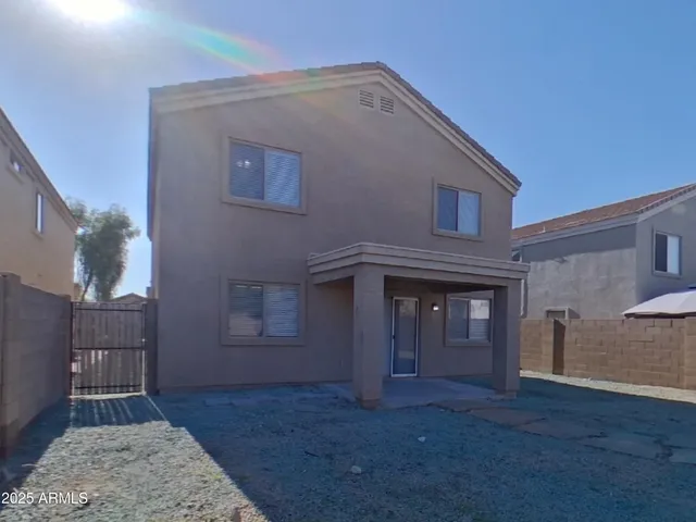 an empty room with a window and a ceiling fan