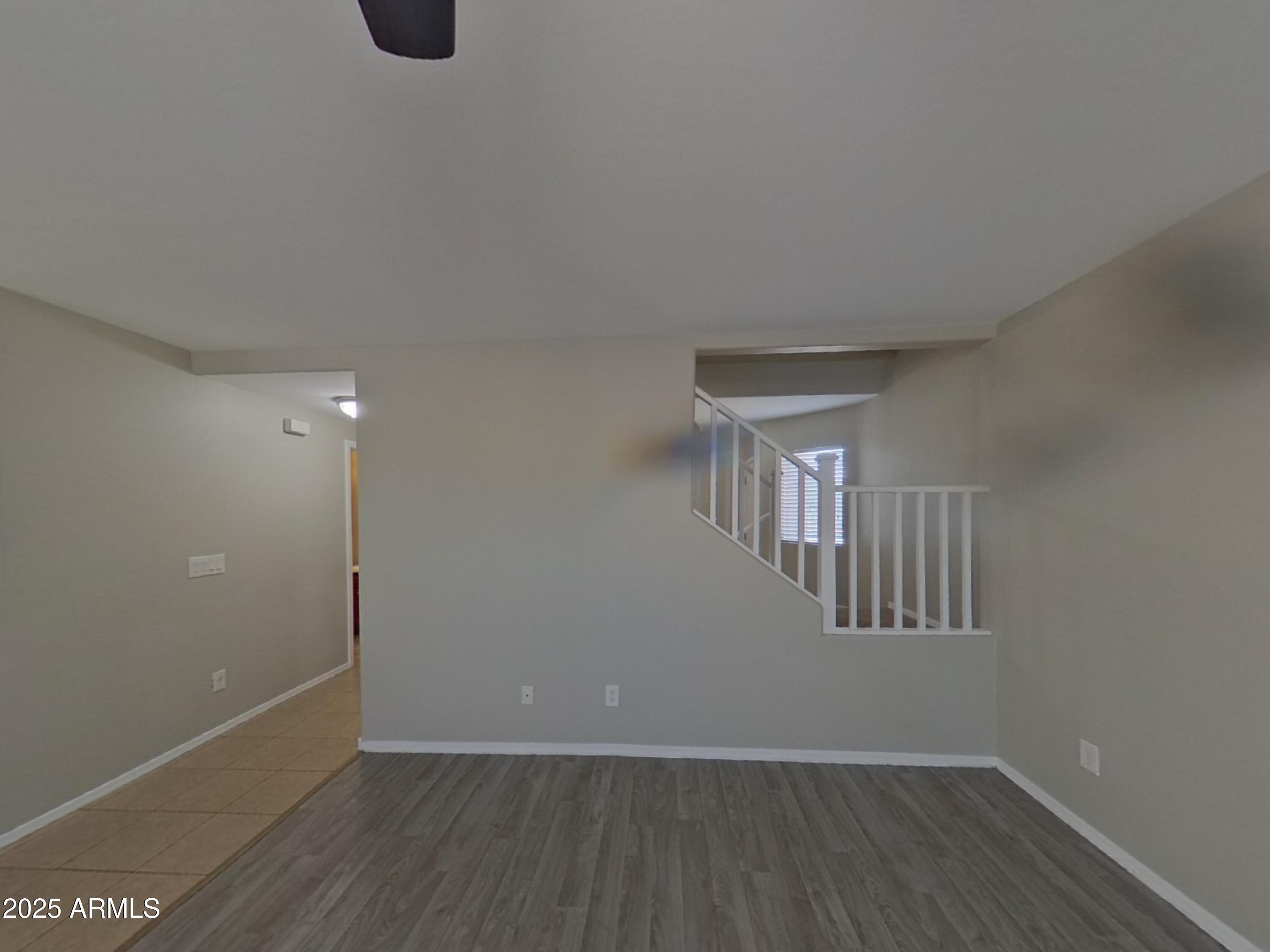 43846 West Magnolia Road Maricopa, AZ 85138 - Photo 2 of 18 a view of an empty room with wooden floor