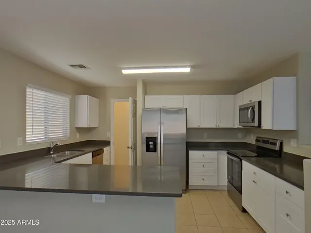 a kitchen with a sink cabinets and utility