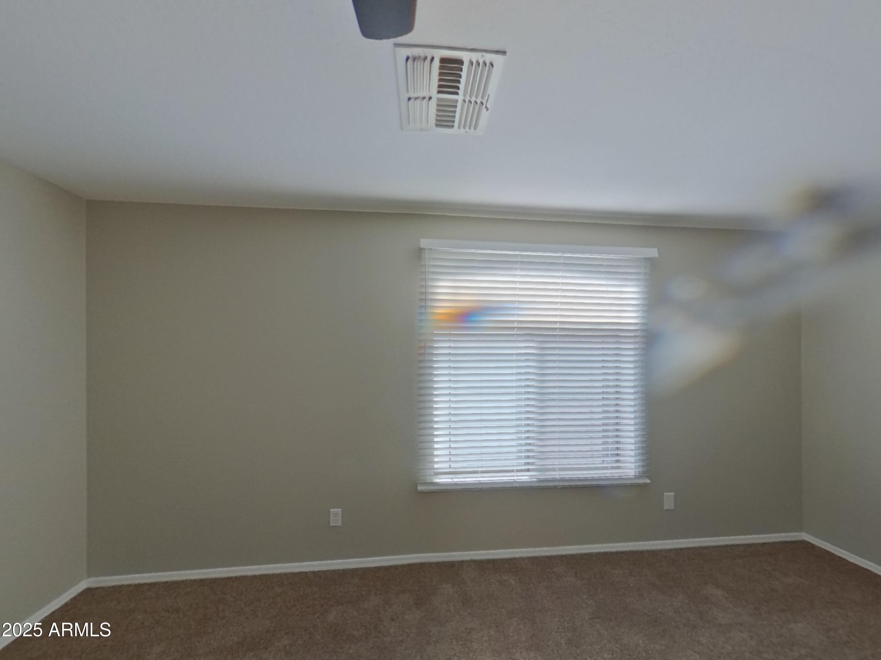 43846 West Magnolia Road Maricopa, AZ 85138 - Photo 5 of 18 a view of an empty room with a window