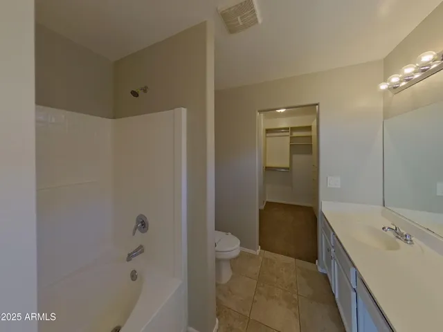 a bathroom with a double vanity sink a large mirror and shower