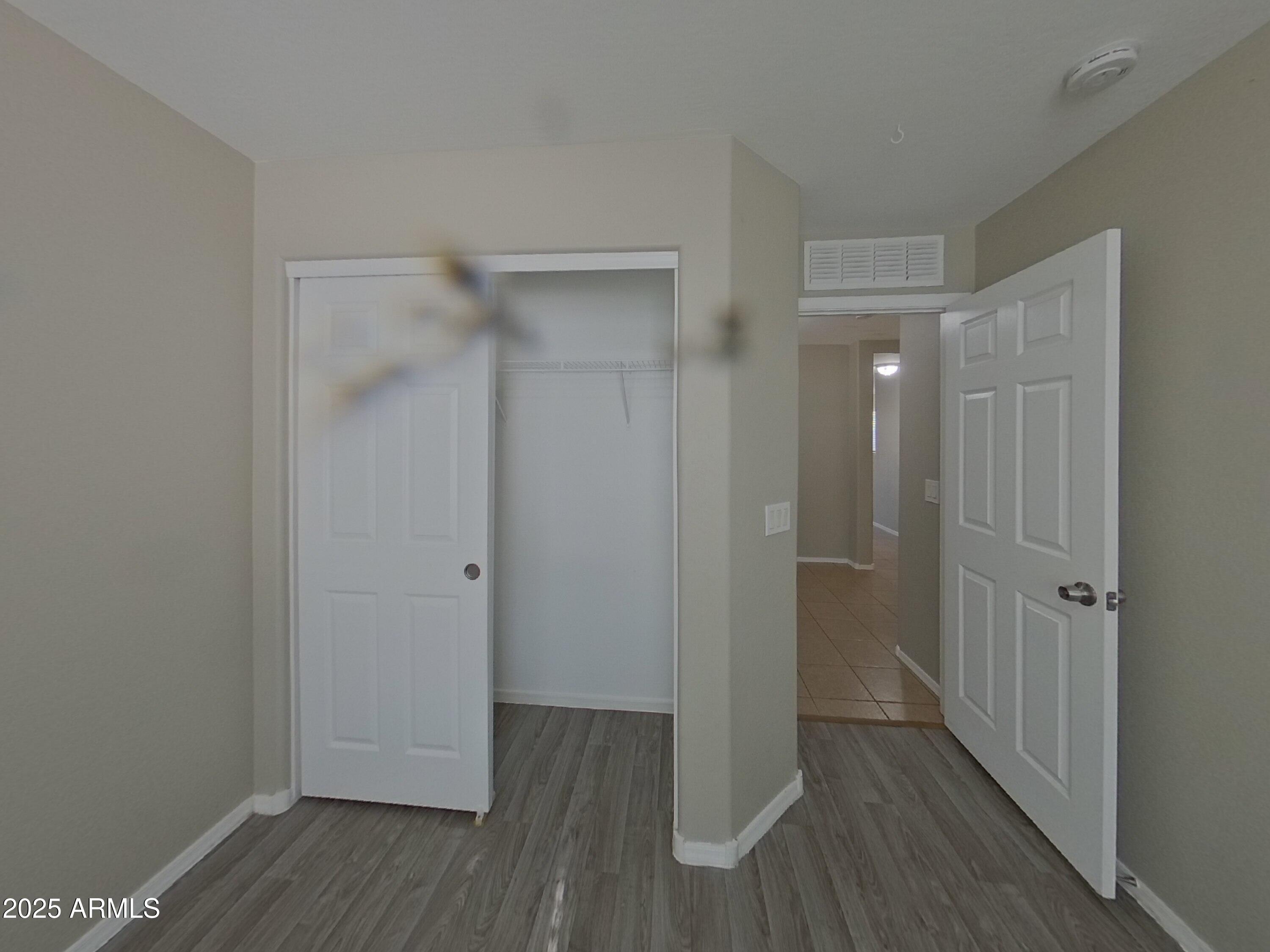 43846 West Magnolia Road Maricopa, AZ 85138 - Photo 8 of 18 a view of a hallway with wooden floor