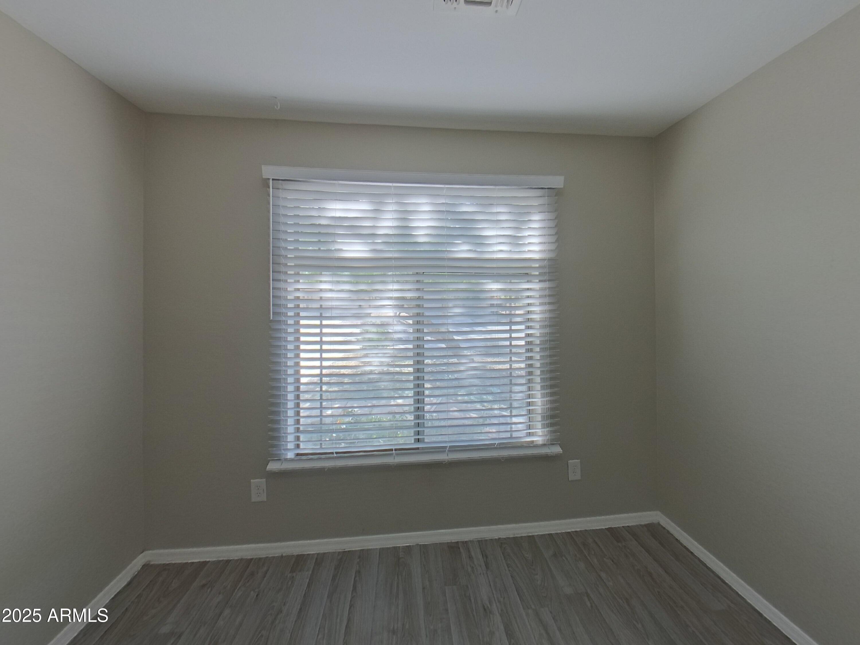 43846 West Magnolia Road Maricopa, AZ 85138 - Photo 9 of 18 a view of a room with wooden floor and a window