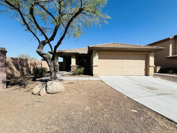 a front view of a house with basket ball court and a fire pit