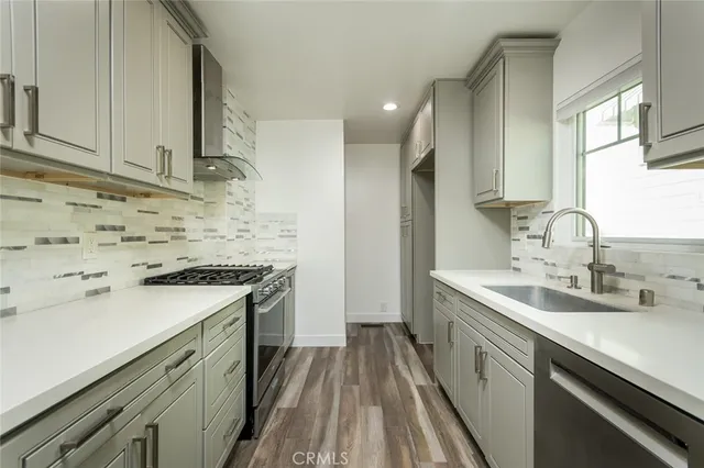 a kitchen with a sink stove and cabinets