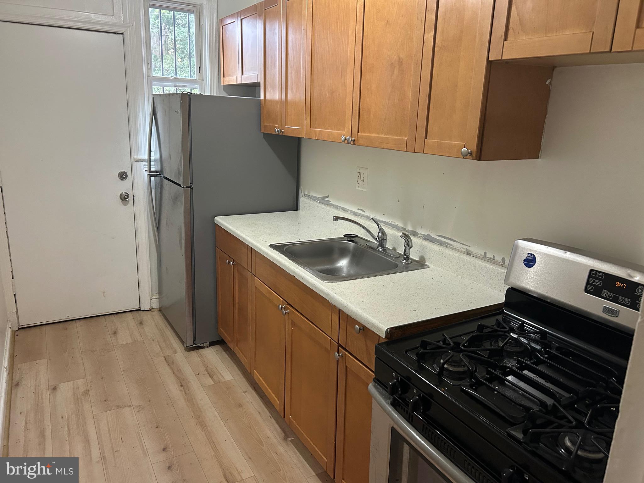 331 Parkland Place Southeast Washington, DC 20032 - Photo 3 of 8 a kitchen with a sink stove and refrigerator