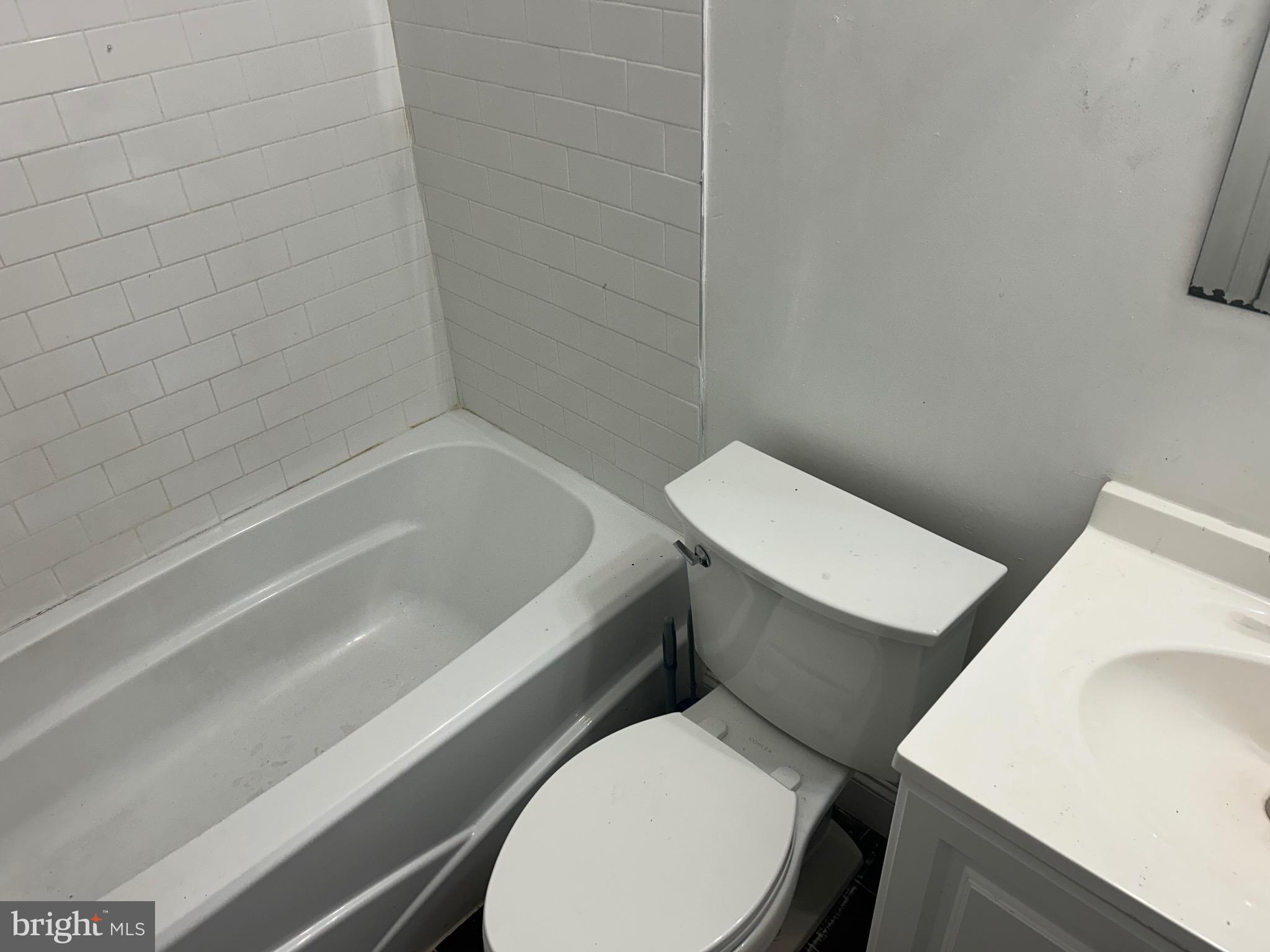 331 Parkland Place Southeast Washington, DC 20032 - Photo 6 of 8 a white toilet sitting next to a bath tub