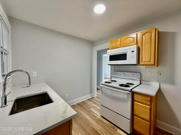 a kitchen with stainless steel appliances a stove a sink and a microwave