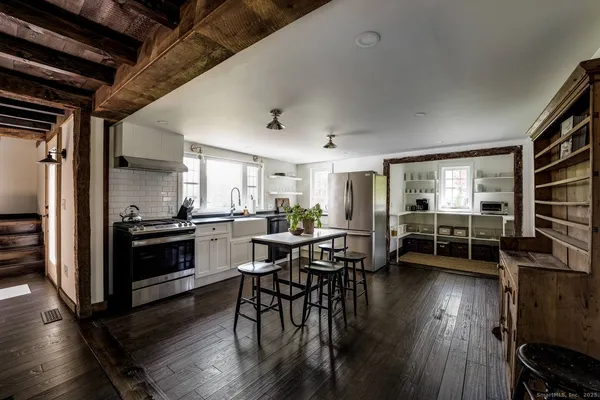 a kitchen with sink table and chairs