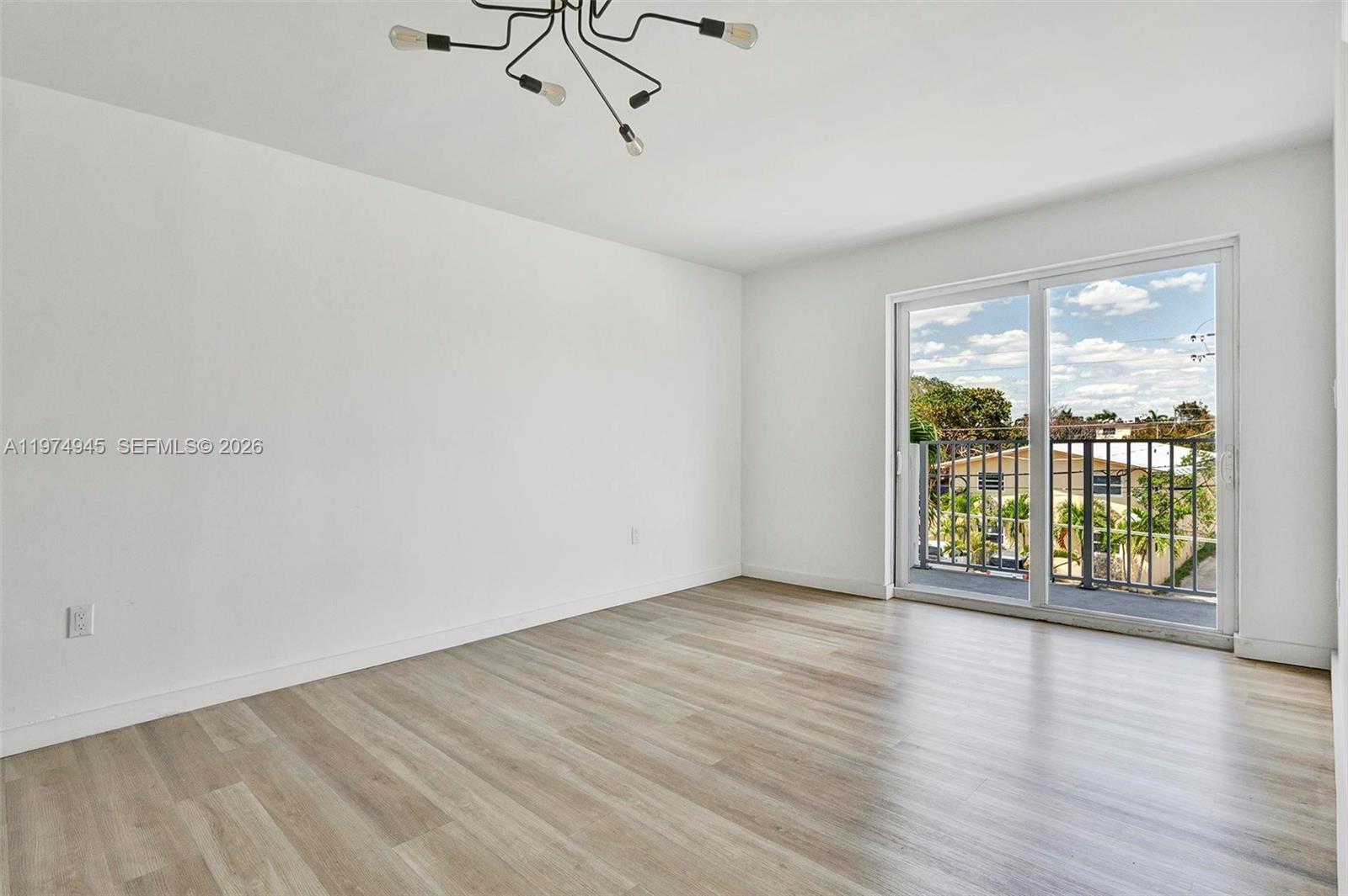 620 Southwest 10th Street, Unit 204 Miami, FL 33130 - Photo 13 of 22 wooden floor in an empty room with a window