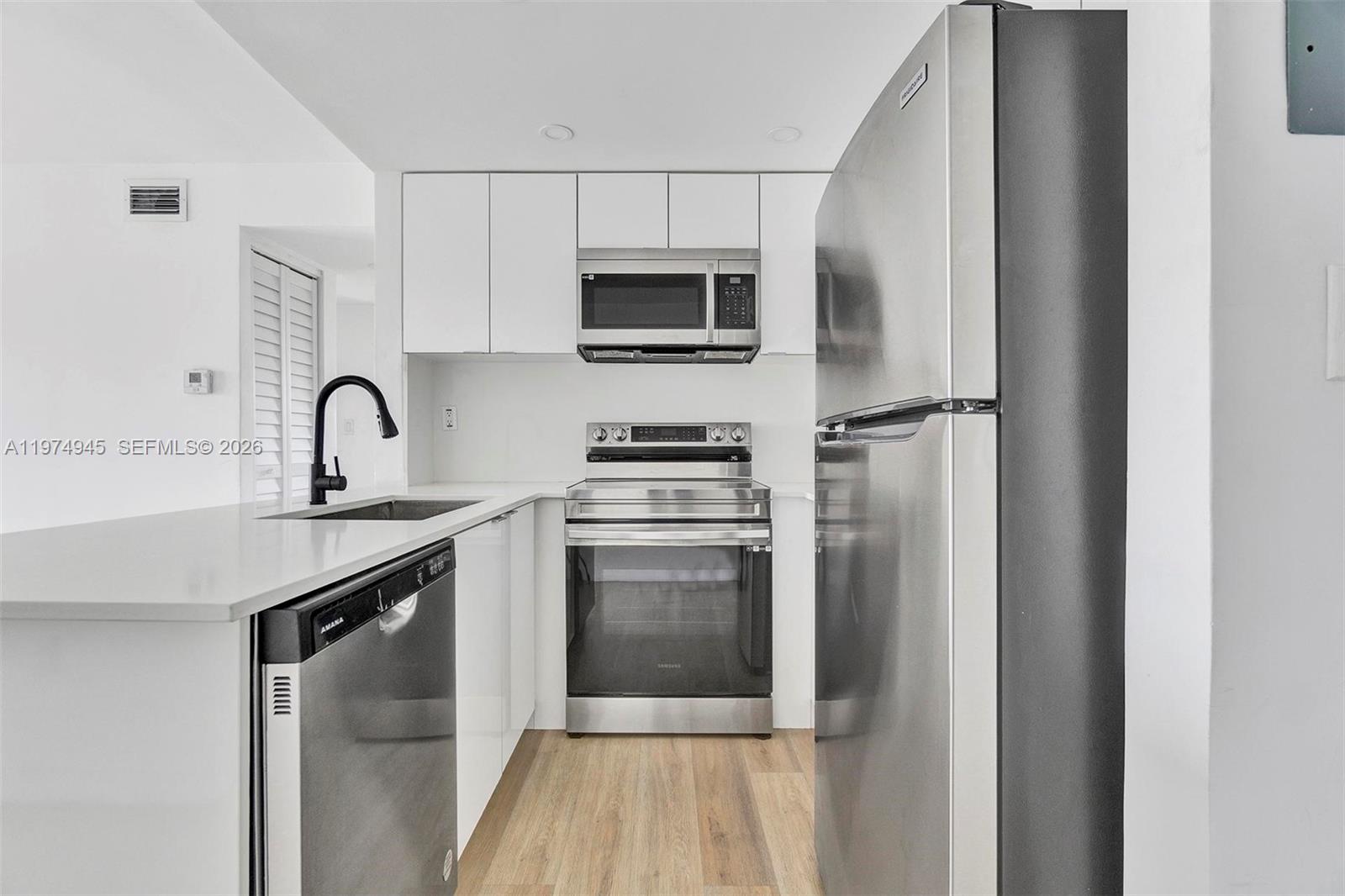 620 Southwest 10th Street, Unit 204 Miami, FL 33130 - Photo 4 of 22 a kitchen with a sink and stainless steel appliances