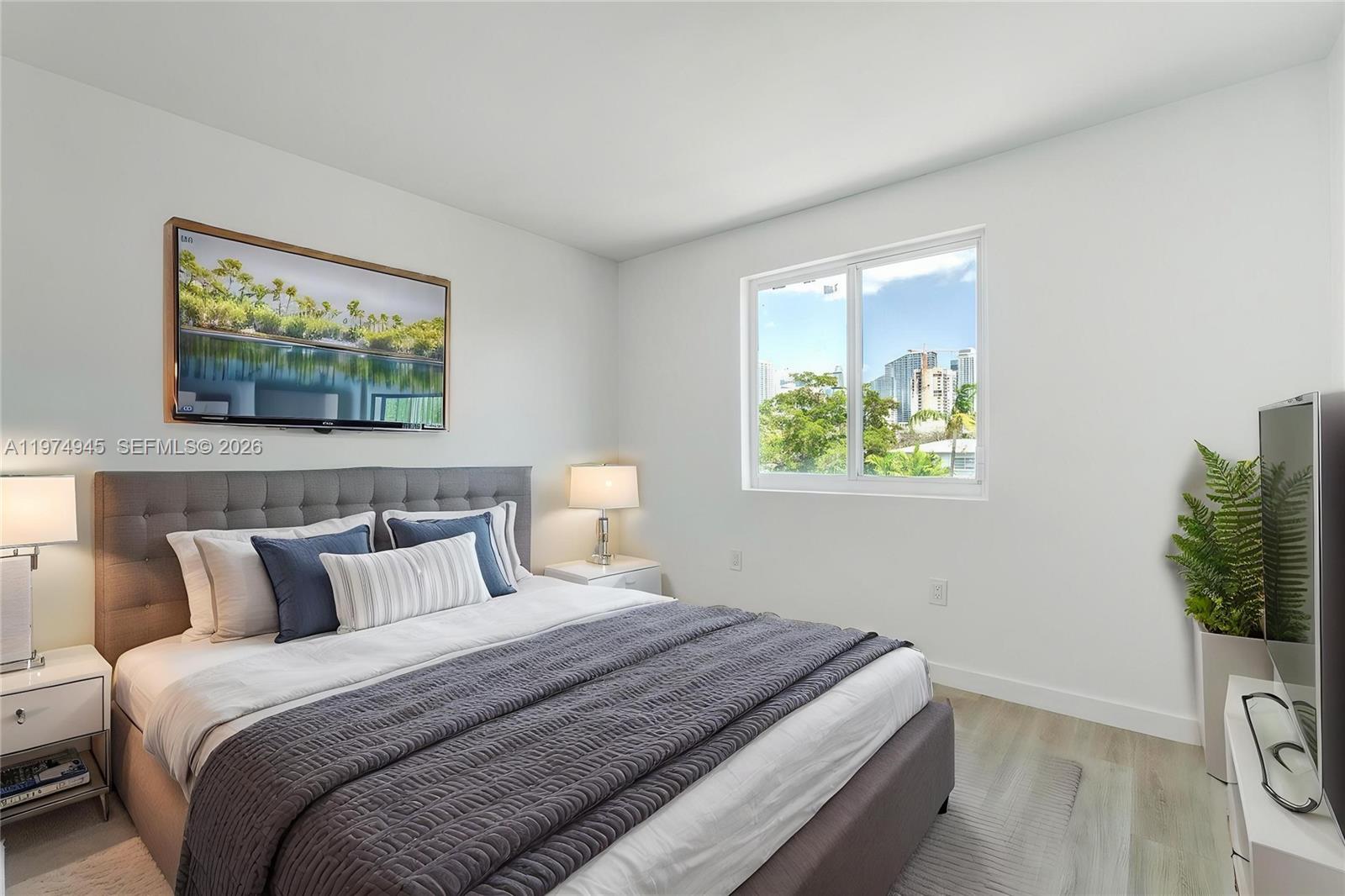 620 Southwest 10th Street, Unit 204 Miami, FL 33130 - Photo 6 of 22 a bedroom with a bed and a painting on the wall