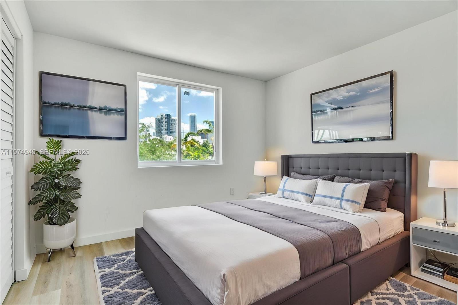 620 Southwest 10th Street, Unit 204 Miami, FL 33130 - Photo 9 of 22 a bedroom with bed and wooden floor