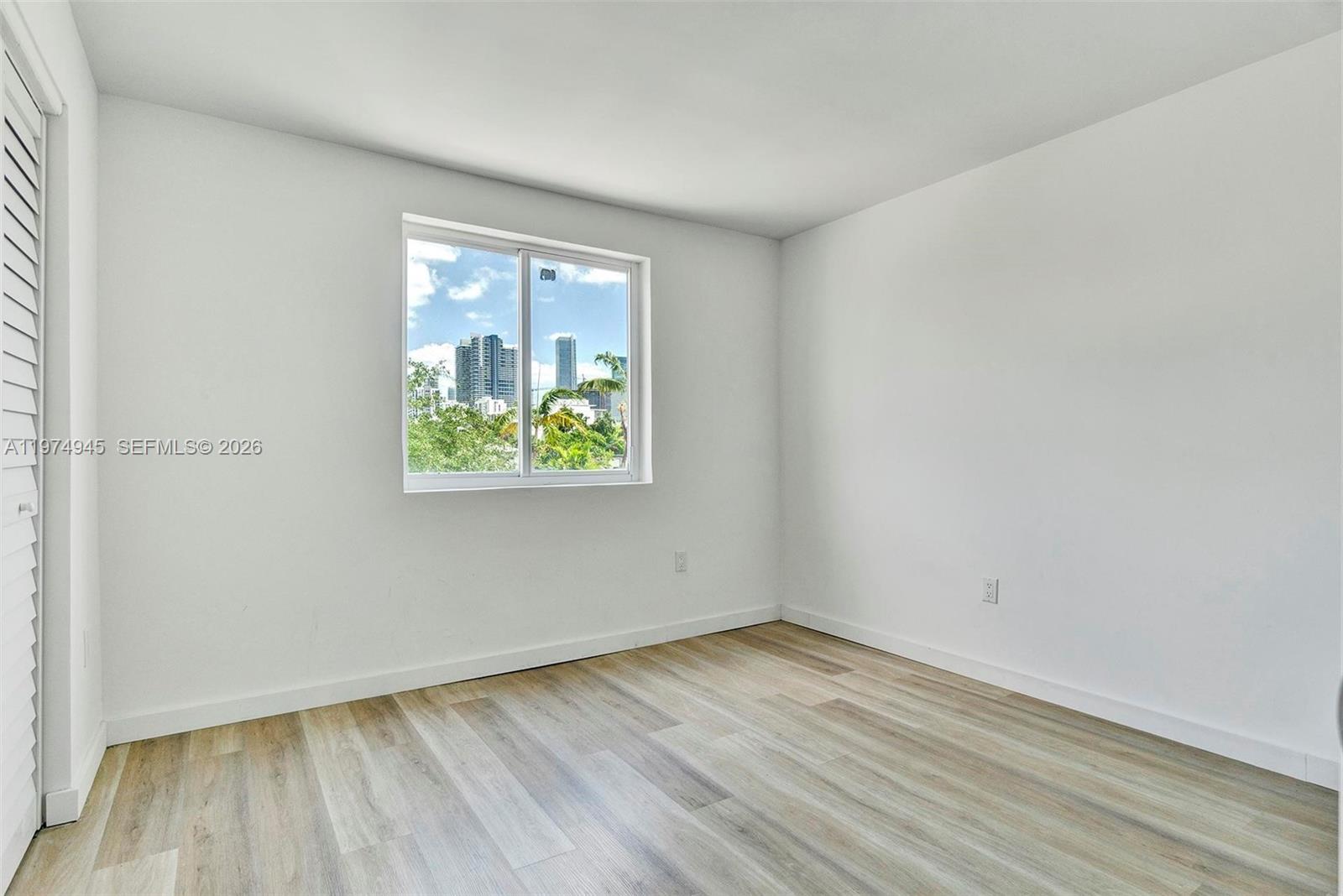 620 Southwest 10th Street, Unit 204 Miami, FL 33130 - Photo 10 of 22 an empty room with wooden floor and windows