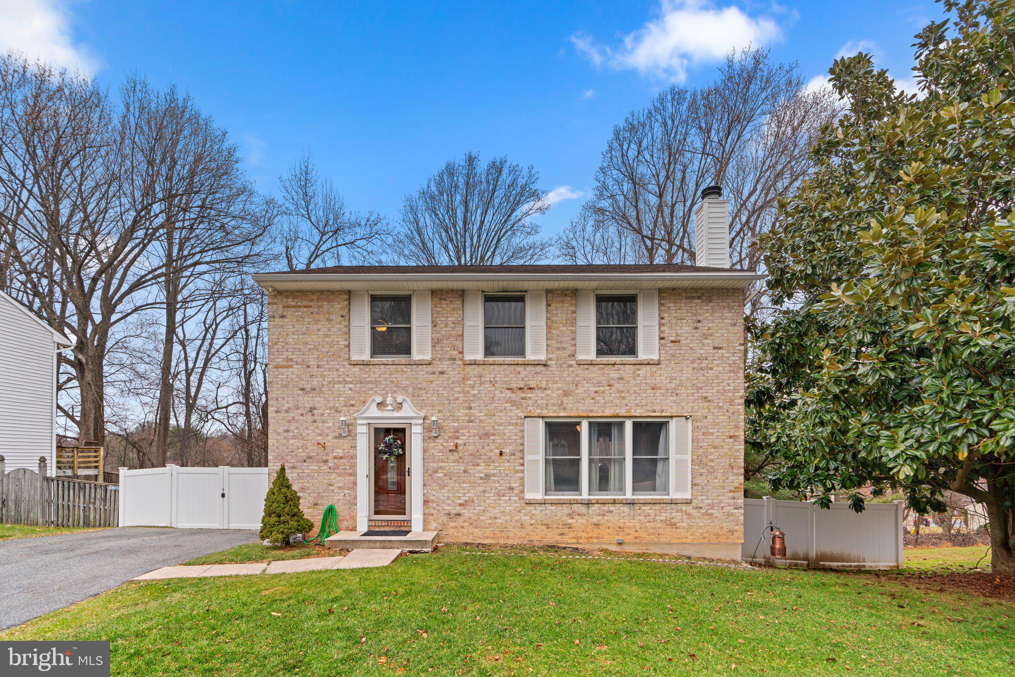 24 Jameson Lane Baltimore, MD 21208 - Photo 1 of 1 a front view of a house with a garden and yard