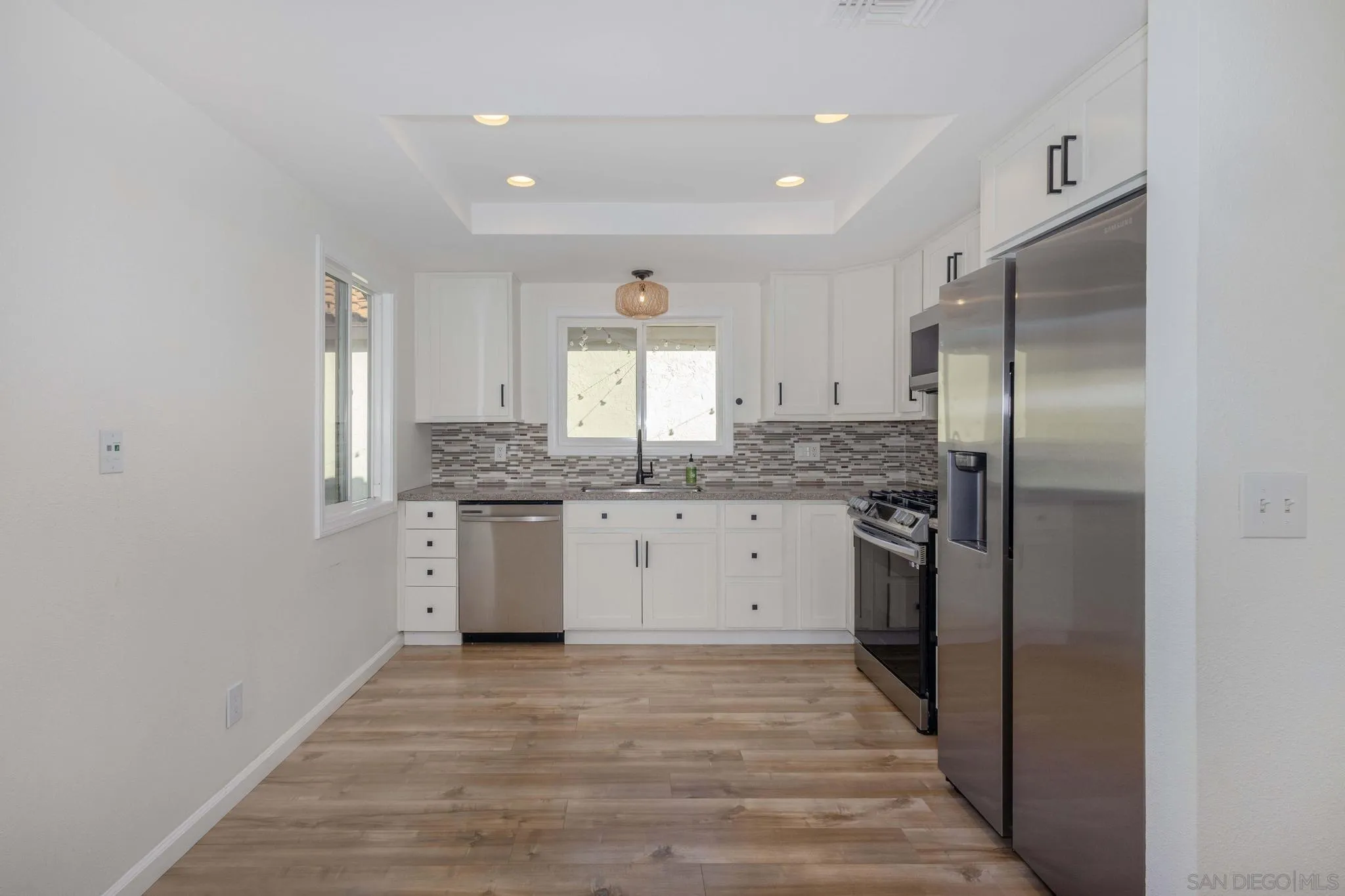 4733 Dalea Place Oceanside, CA 92057 - Photo 12 of 30 a kitchen with a refrigerator sink and cabinets