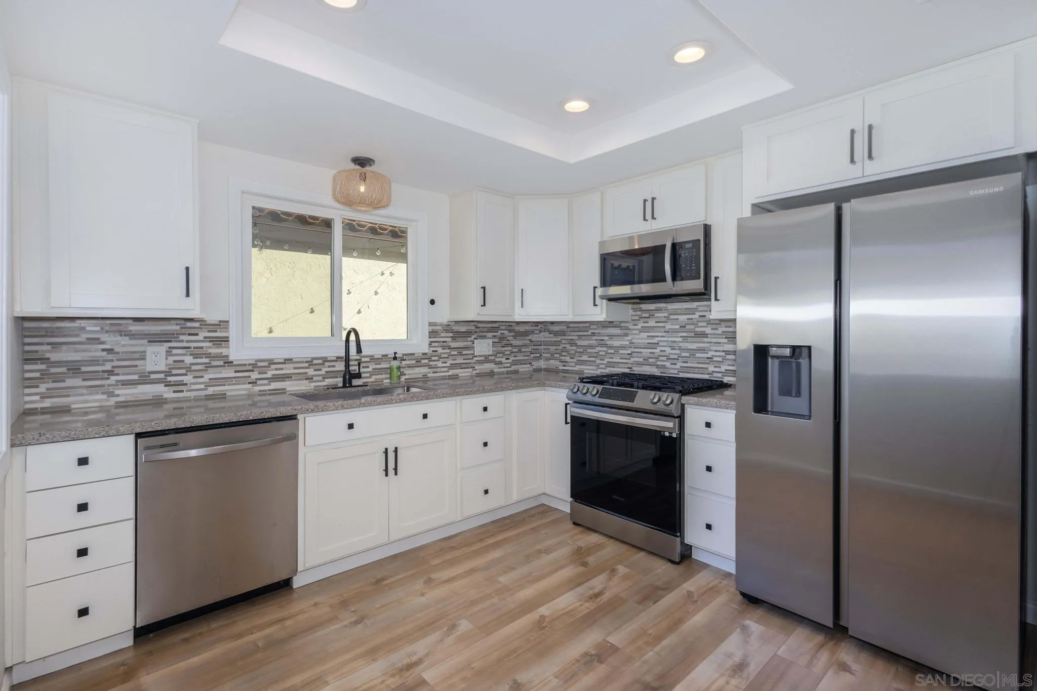 4733 Dalea Place Oceanside, CA 92057 - Photo 13 of 30 a kitchen with granite countertop stainless steel appliances a stove sink and microwave