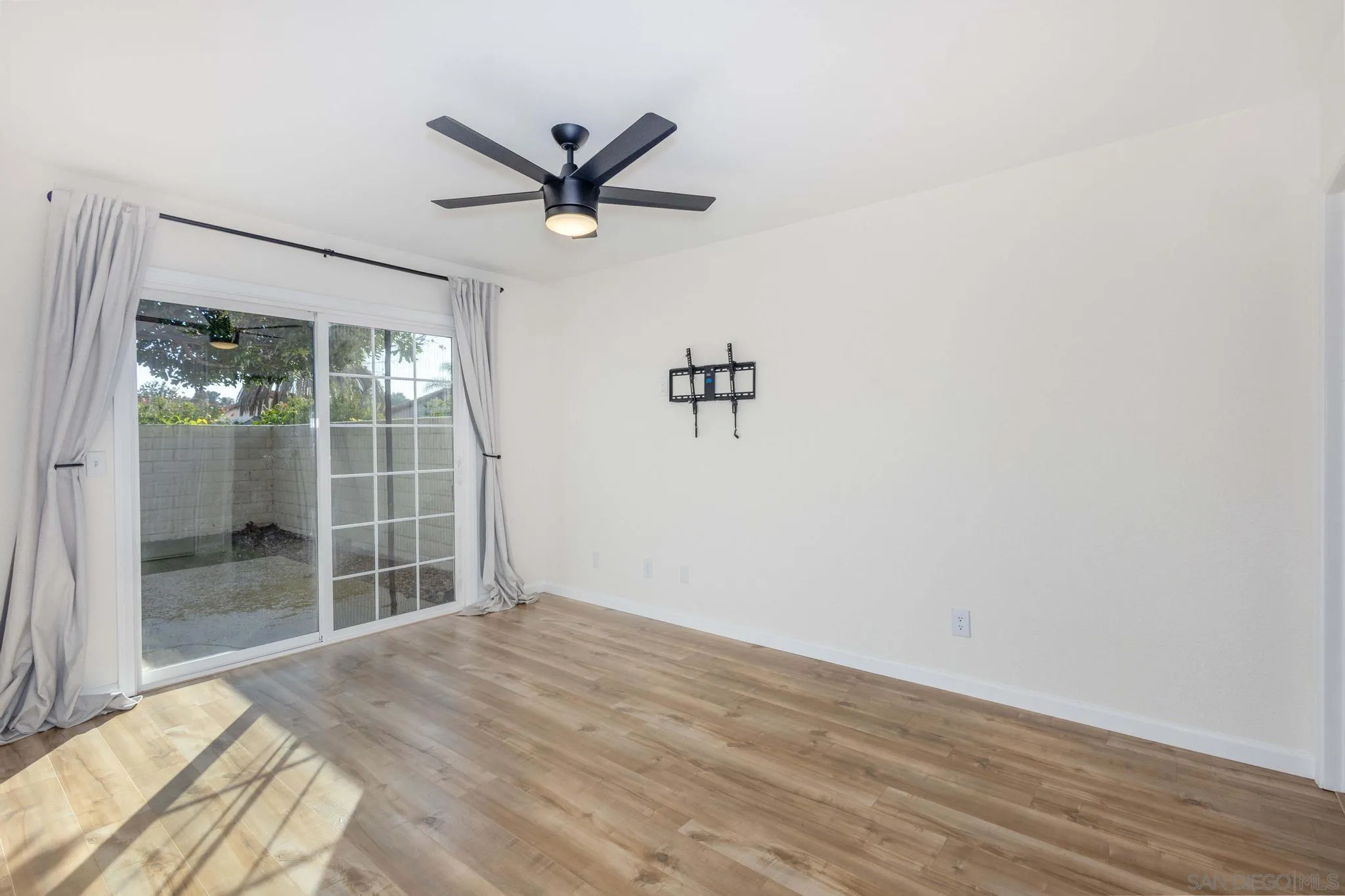 4733 Dalea Place Oceanside, CA 92057 - Photo 18 of 30 a view of a livingroom with a hardwood floor and a ceiling fan
