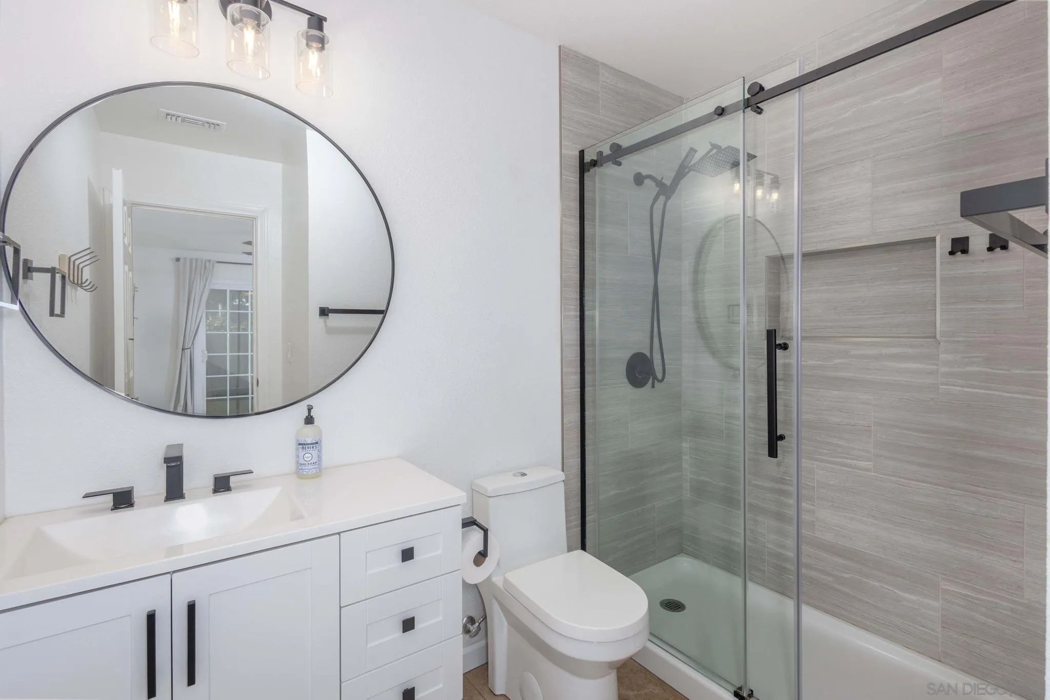 4733 Dalea Place Oceanside, CA 92057 - Photo 21 of 30 a bathroom with a sink a toilet and a mirror