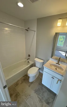 a bathroom with a sink a toilet and a bathtub