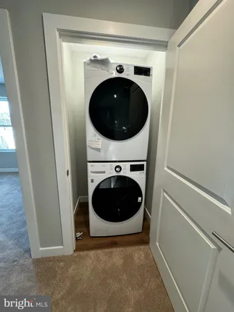 a view of a hallway with a washer and dryer