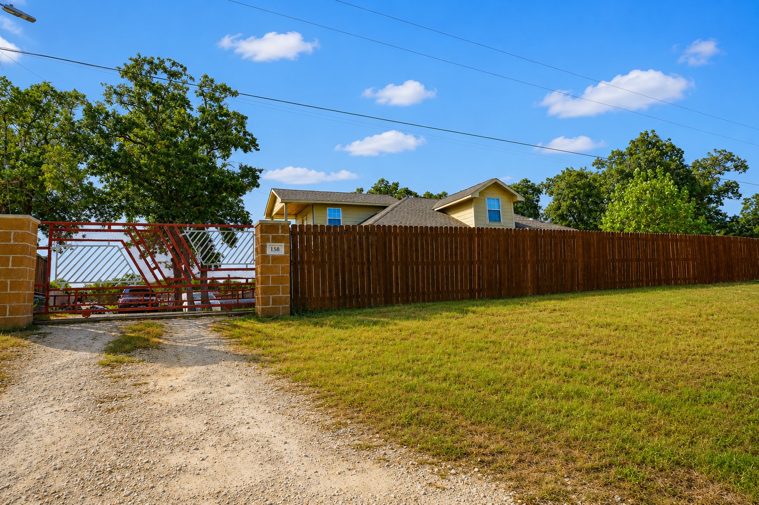 158 Buena Fortuna Road Elgin, TX 78621 - Photo 39 of 40 Securely fenced estate with a private gate and sprawling grounds.