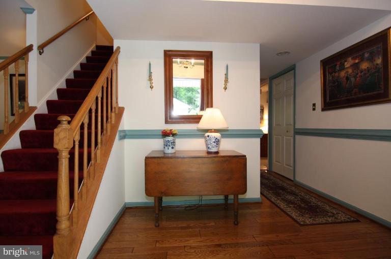 9224 Rockefeller Lane Springfield, VA 22153 - Photo 16 of 25 Foyer has hardwoods and leads to the kitchen