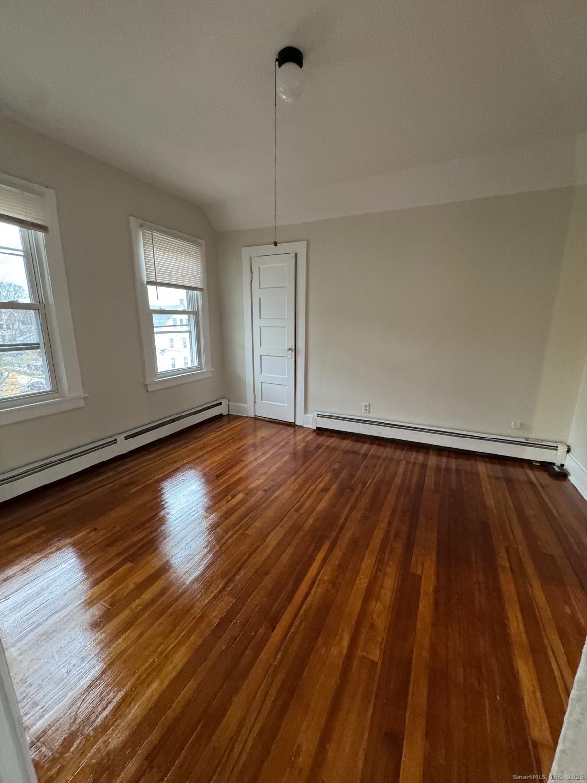 328 Chapman Street New Britain, CT 06051 - Photo 6 of 8 wooden floor in an empty room with a window