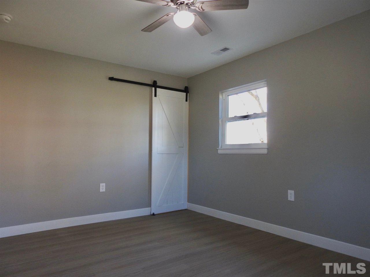 41 Peace Street Roxboro, NC 27573 - Photo 15 of 20 wooden floor in an empty room with a window